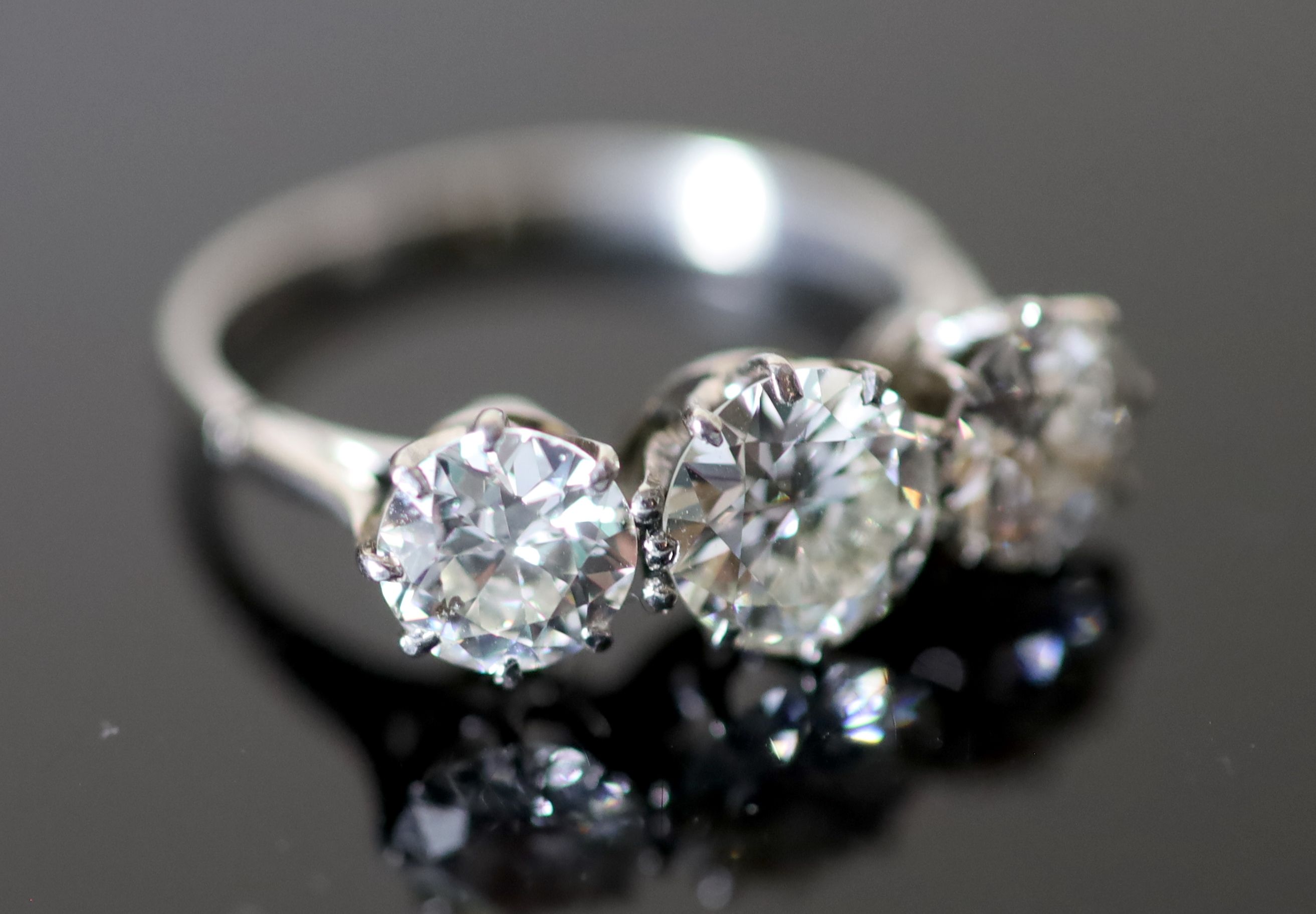 A platinum and three stone diamond ring,